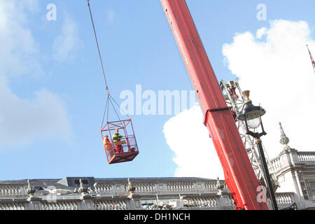 Westminster London,UK. 29th October 2013. A construction crane is lifted using lifting equipment and winches a day after it collapsed on top of the roof of the cabinet office building in Whitehall caused by the high winds during the St Jude's storm Credit:  amer ghazzal/Alamy Live News Stock Photo