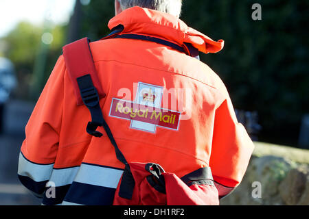 royal mail postman on his round carrying a post bag Stock Photo Alamy