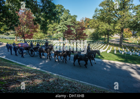 Service members from the United States Army's Old Guard and the Coast Guard Ceremonial Honor Guard participate in an Inurnmet service in the Arlington National Cemetary, Tuesday, Oct. 15, 2013. Servicemembers at the Arlington National Cemetary perform gra Stock Photo