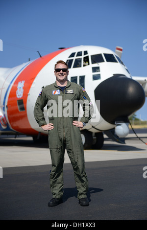 Lt. j.g. Matthew Chase is shown in front of an HC-130 Hercules airplane at Coast Guard Air Station Barbers Point in O'ahu, Hawaii July 31, 2013. Chase graduated from the Coast Guard Academy in 2011 and subsequently fulfilled his lifelong dream of becoming Stock Photo