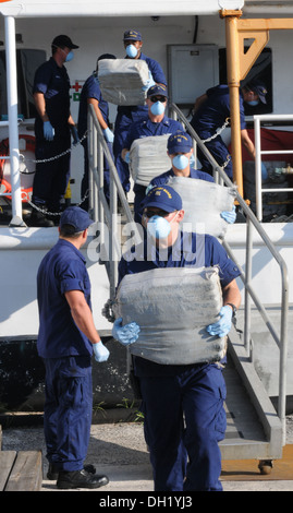 Crewmembers aboard Coast Guard Cutter Venturous, homeported in St. Petersburg, Fla., offloads $23 million worth of cocaine at Sector St. Petersburg Tuesday, Oct. 22, 2013. The crew returned with the contraband after a 40-day patrol in support of Operation Stock Photo