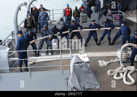 Sailors aboard the aircraft carrier USS Theodore Roosevelt (CVN 71) participate in a sea and anchor detail as the ship departs Naval Station Norfolk. Theodore Roosevelt is underway conducting carrier qualifications. Stock Photo