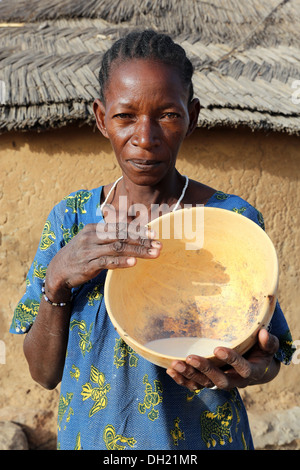 A Fulani woman presenting calabash with fresh milk, Burkina Faso Stock Photo