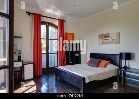 Red Curtains On French Windows In Spanish Bedroom With Black