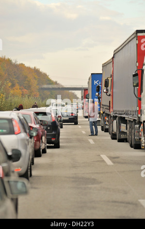 People leaving their cars during a traffic jam on the A61 Autobahn, motorway to look for the reason of the congestion, between Stock Photo