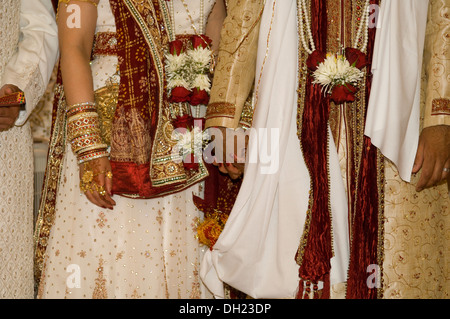 Bride and Groom dressed in all their finery celebrating their Traditional Hindu wedding. Stock Photo