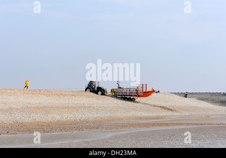 The Rye Harbour lifeboat is retrieved over the shingle banks at the mouth of the River Ouse. Rye Harbour. Stock Photo