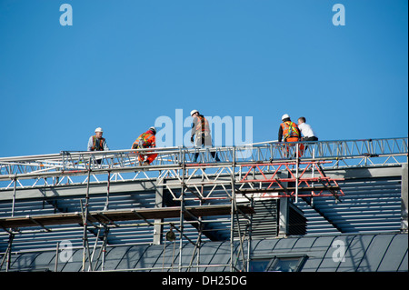 Roofers working on Scaffolding safety Harness H&S Stock Photo