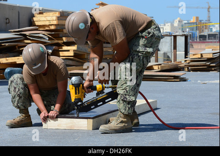 NAVAL SUPPORT ACTIVITY BAHRAIN (Oct. 22, 2013) Utilitiesman 3rd Class Charity Hughes (left) and Builder 3rd Class Juan Robledo, Stock Photo