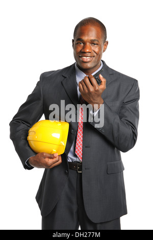 African American businessman holding hardhat and radio isolated over white background Stock Photo
