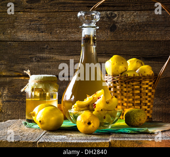 Tincture of quince and fruit on a wooden table Stock Photo