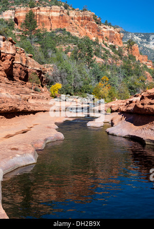 Reflection of cliffs in creek at Slide Rock State Park in Oak Creek Canyon near Sedona, Arizona Stock Photo