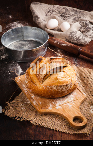 Freshly baked traditional bread on wooden table Stock Photo