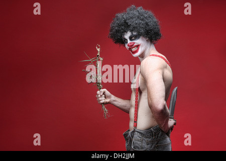 Evil Spooky Clown Portrait on Red Background Stock Photo
