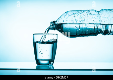 bottled water and a glass Stock Photo