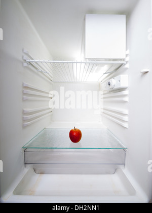 apple in an empty refrigerator Stock Photo