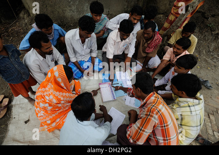 indian people learning political party workers explaining how to vote on an electronic voting machine at Dongajora village kolkata calcutta west bengal India Asia Stock Photo