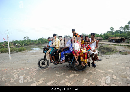 twelve indian people on one motor tricycle kolkata calcutta west bengal India Asia Stock Photo