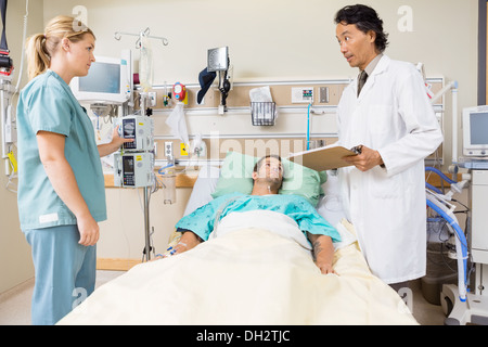 Doctor Discussing Medical Report With Nurse Stock Photo