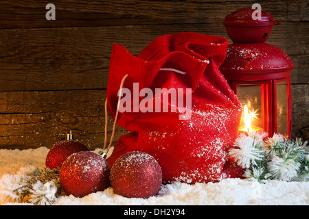 Christmas lantern gifts and baubles on snow abstract background Stock Photo