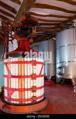 Press and Stainless steel fermentation tanks vessels in winery Stock Photo