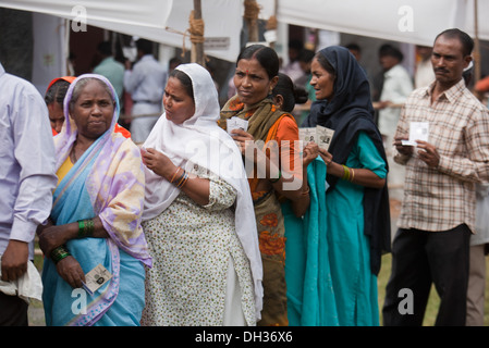 Indian men and women waiting in queue to vote in elections Bombay Mumbai Maharashtra India Asia Indian elections voting line Stock Photo