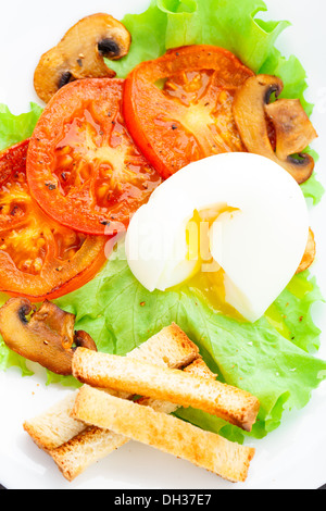 Light breakfast with soft egg, tomato and croutons Stock Photo