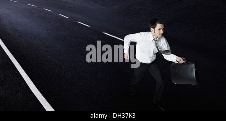 Businessman running on the road Stock Photo