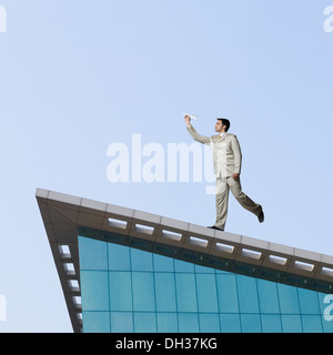 Low angle view of a businessman throwing a paper airplane Stock Photo