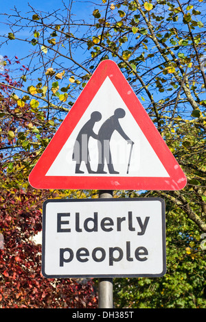 Traffic sign warning that elderly people maybe trying to cross the road. Stock Photo