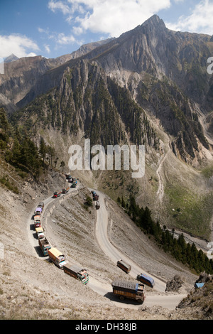Convoy of cargo trucks negotiate the hazardous Zoji La Himalayan Pass, Kashmir, India Stock Photo