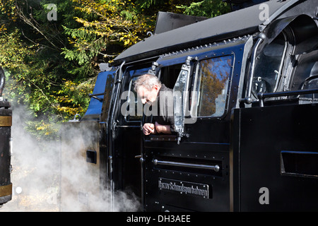 A Steam locomotive and engine driver on the Harz Mountain Railway at eisfelder Tahmuhle Stock Photo