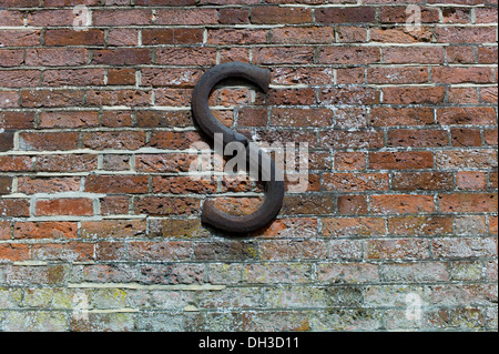 An S shaped decorative but functional tension reinforcing Tie Rod wawasher mainly seen on old buildings to stop bowing of walls Stock Photo