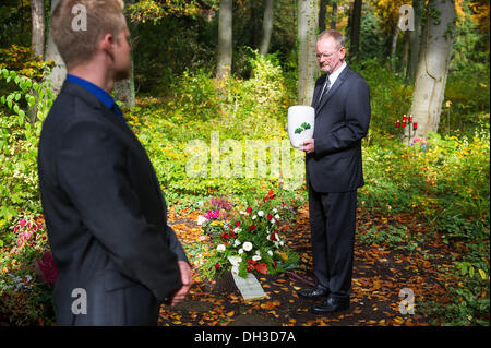 Saarbruecken, Germany. 22nd Oct, 2013. The undertakers Hubert Laubach (R) and Hubert Marc Laubach stand in the area for forest burials of the main cemetery in Saarbruecken, Germany, 22 October 2013. The two undertakers found voluntary mourners for decendents without relatives. Photo: Oliver Dietze/dpa/Alamy Live News Stock Photo