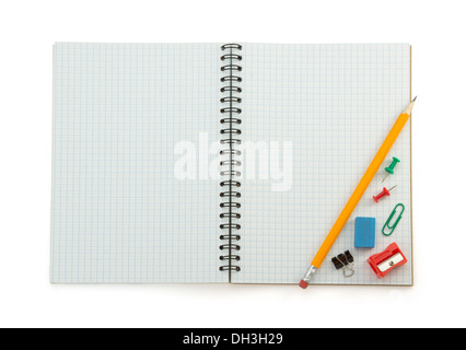 school supplies on checked notebook isolated at white background Stock Photo
