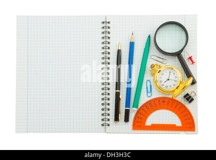 school supplies on checked notebook isolated at white background Stock Photo
