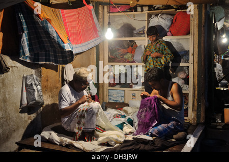 Tailors in family shop, Kolkata, India Stock Photo