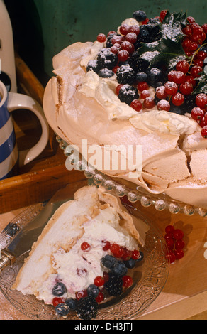 Meringue pavlova topped with red and black currants and black berries Stock Photo