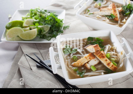 Vegan Pho soup with rice noodles, sprouts and fried tofu. Stock Photo