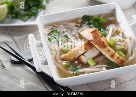 Vegan Pho soup with rice noodles, sprouts and fried tofu. Stock Photo