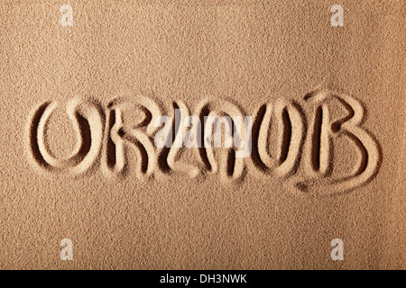 Writing in the sand 'URLAUB' or 'holiday' Stock Photo
