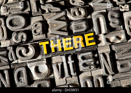 Old lead letters forming the word "THERE" Stock Photo