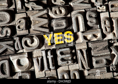 Old lead letters forming the word "yes" Stock Photo