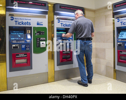 Man Purchasing Metro North Transit Train Tickets at Self Serve Vending Machine, Grand Central Terminal, NYC Stock Photo