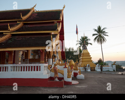 A view of Wat Chomkao Manilat Buddhist temple at sunset in Huay Xai, Bokeo, Laos. Stock Photo