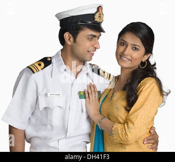 Close-up of a navy officer embracing his wife Stock Photo