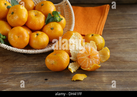 fresh ripe orange mandarins (tangerines) on a wooden table Stock Photo