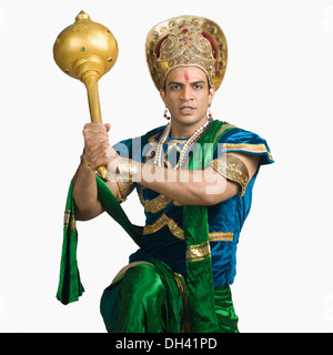 Portrait of a young man dressed-up as Bhima and holding a mace Stock Photo