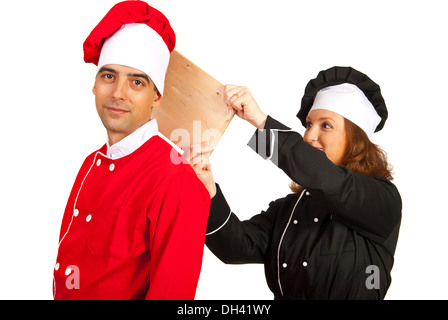 Chefs couple having fun and woman prepare to touching man with wooden board Stock Photo