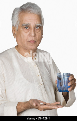 Portrait of a senior man taking medicine Stock Photo